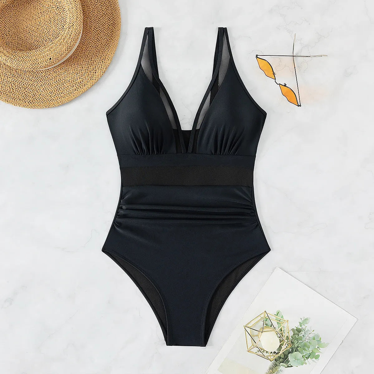 Black halter neck one-piece swimsuit for women on a mannequin, showing sleeveless design and briefs style.
