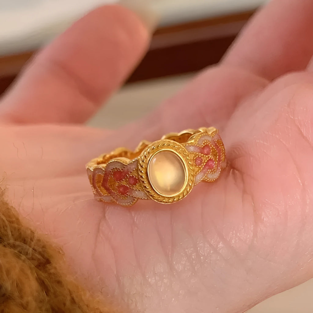 Geometric open mouth ring with pink crystal enamel detail on gold-plated copper band