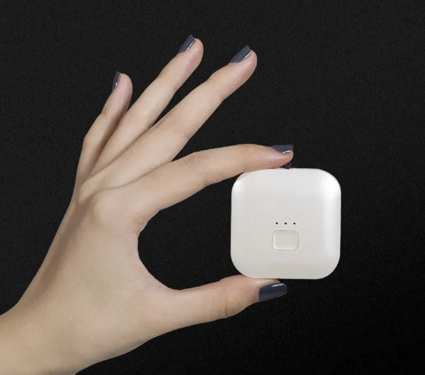 Mini USB rechargeable wearable air purifier necklace in pink, showing compact dimensions.