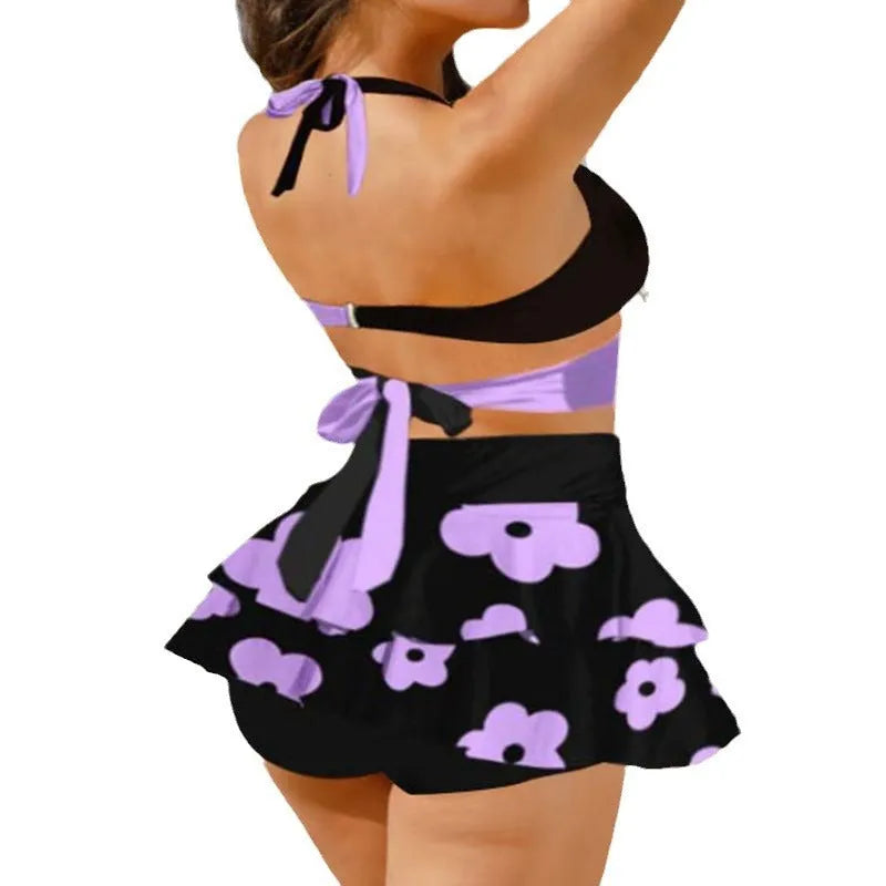 Women's purple bikini swimsuit with split skirt and lace-up detail, high waist backless design