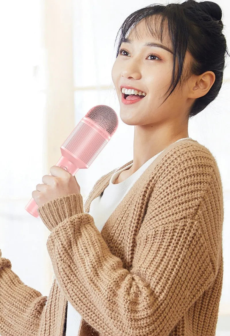 Wireless Bluetooth karaoke microphone in pink, blue, or green colour on a plain background.