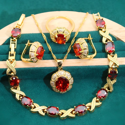 Four piece 18K gold plated jewellery set with coloured cubic zirconia stones including necklace earrings ring and bracelet