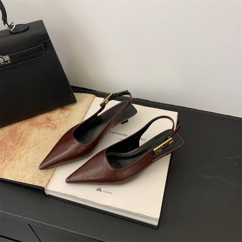 Thin low heel strap pointed leather shoes for women, black colour, side view showing heel height and ankle strap