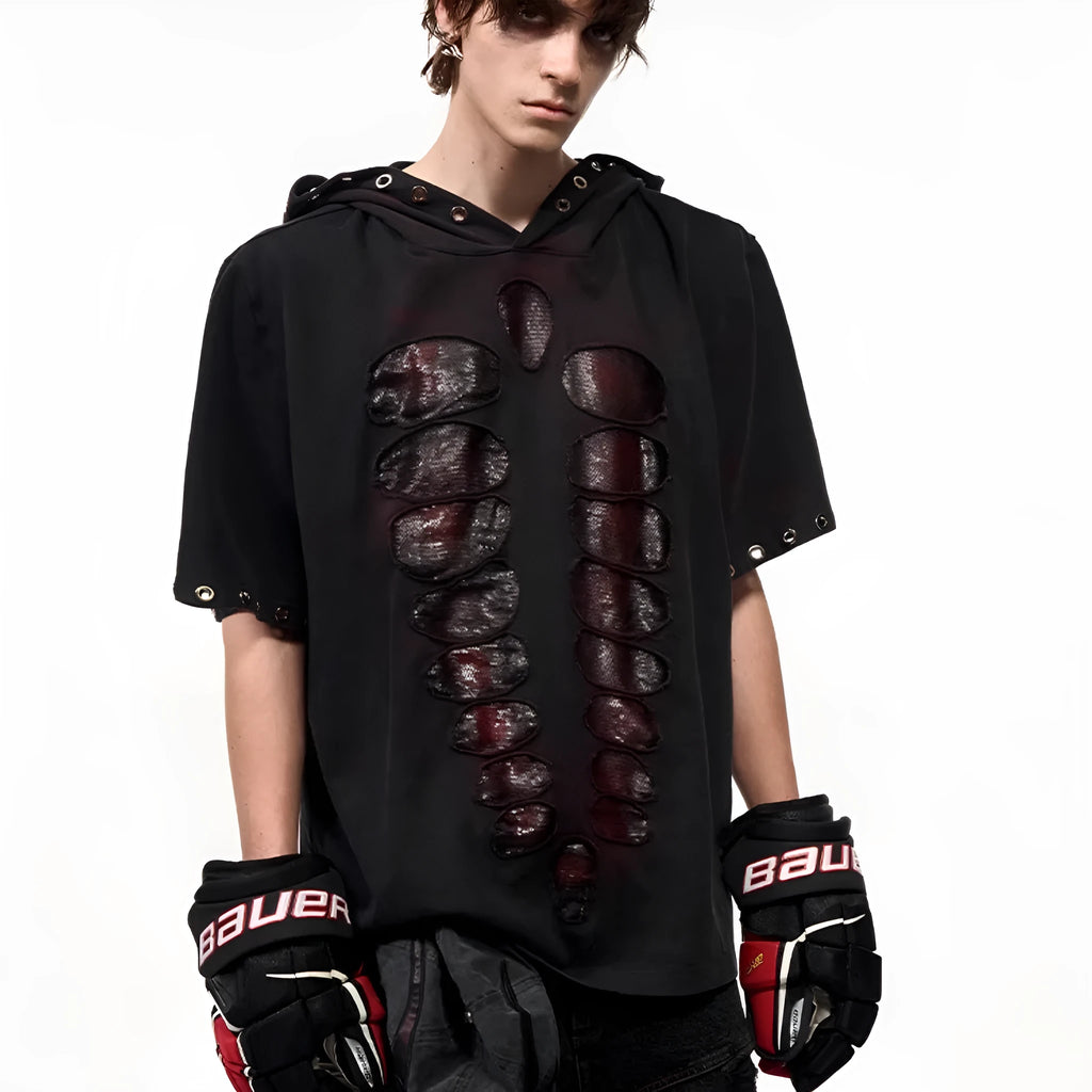 Black loose-fit men's hooded T-shirt covered in reflective sequins, shown in a casual setting.