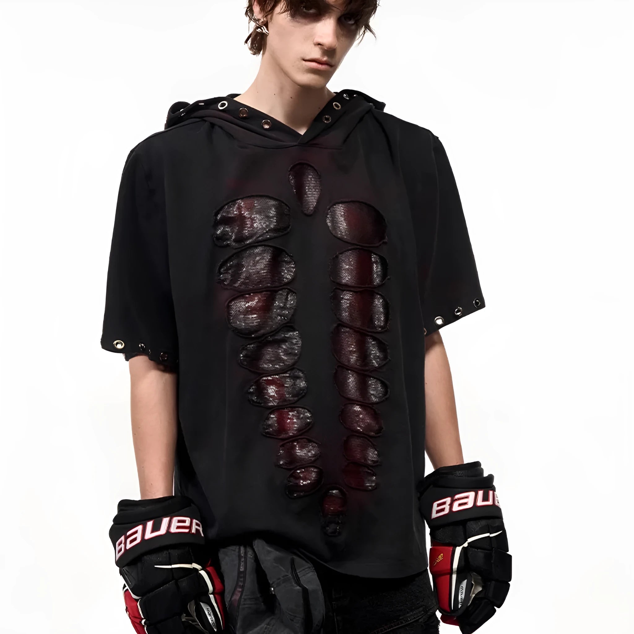 Black loose-fit men's hooded T-shirt covered in reflective sequins, shown in a casual setting.