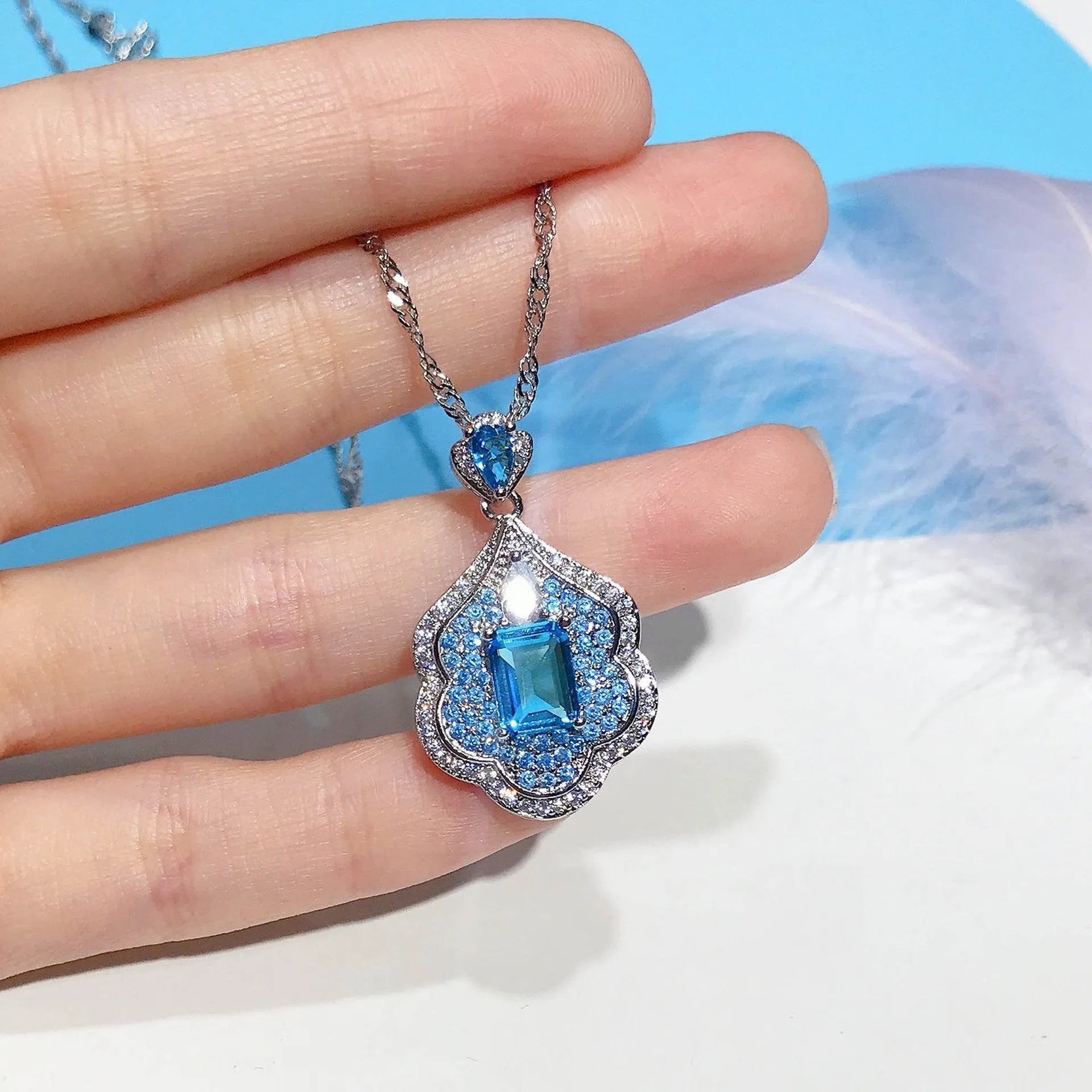 Sea blue mirror finish copper geometry pendant without chain, shown on neutral background