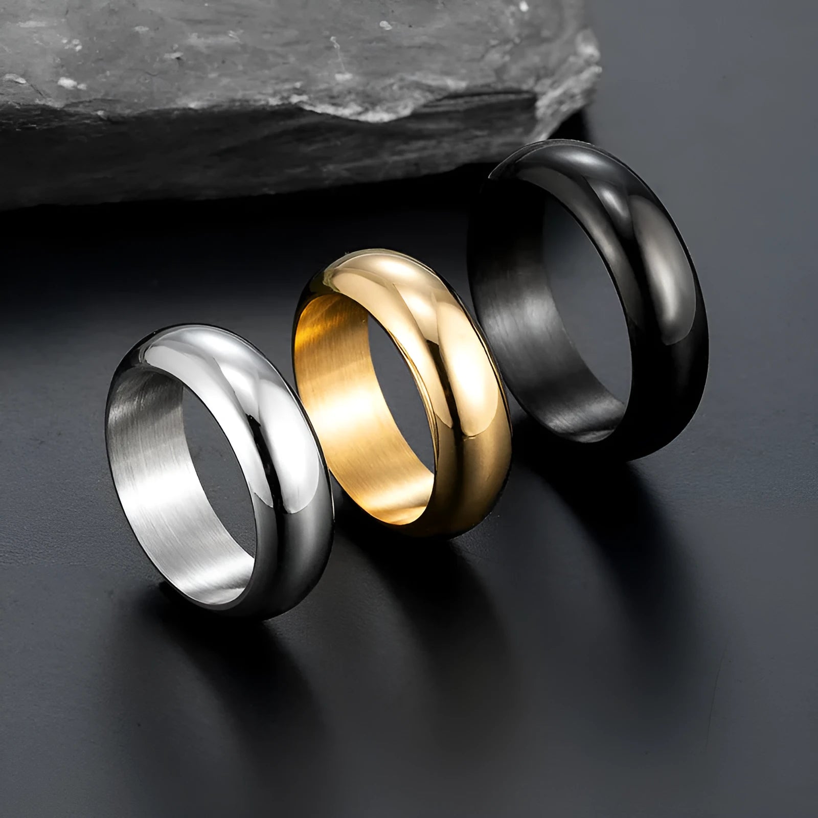 Glossy electroplated titanium steel ring in gold colour on a white background.