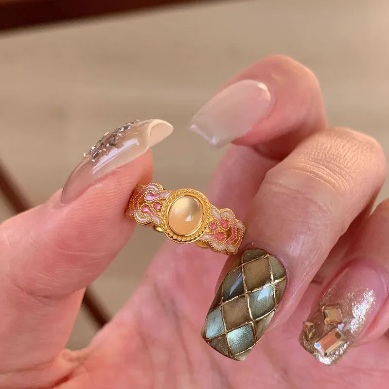 Geometric open mouth ring with pink crystal enamel detail on gold-plated copper band