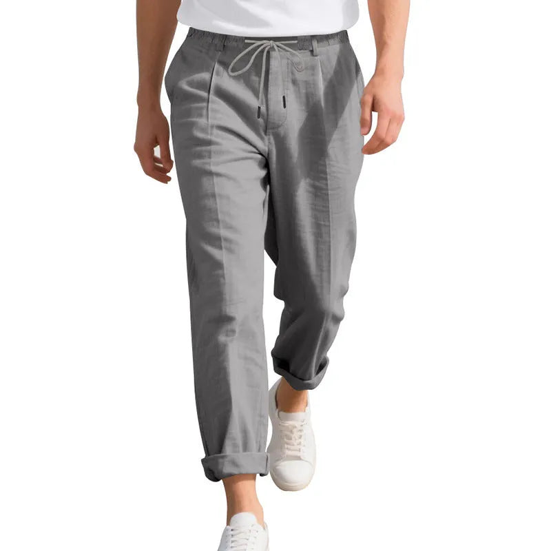 Men's light grey linen casual trousers with a loose straight leg and drawstring waist
