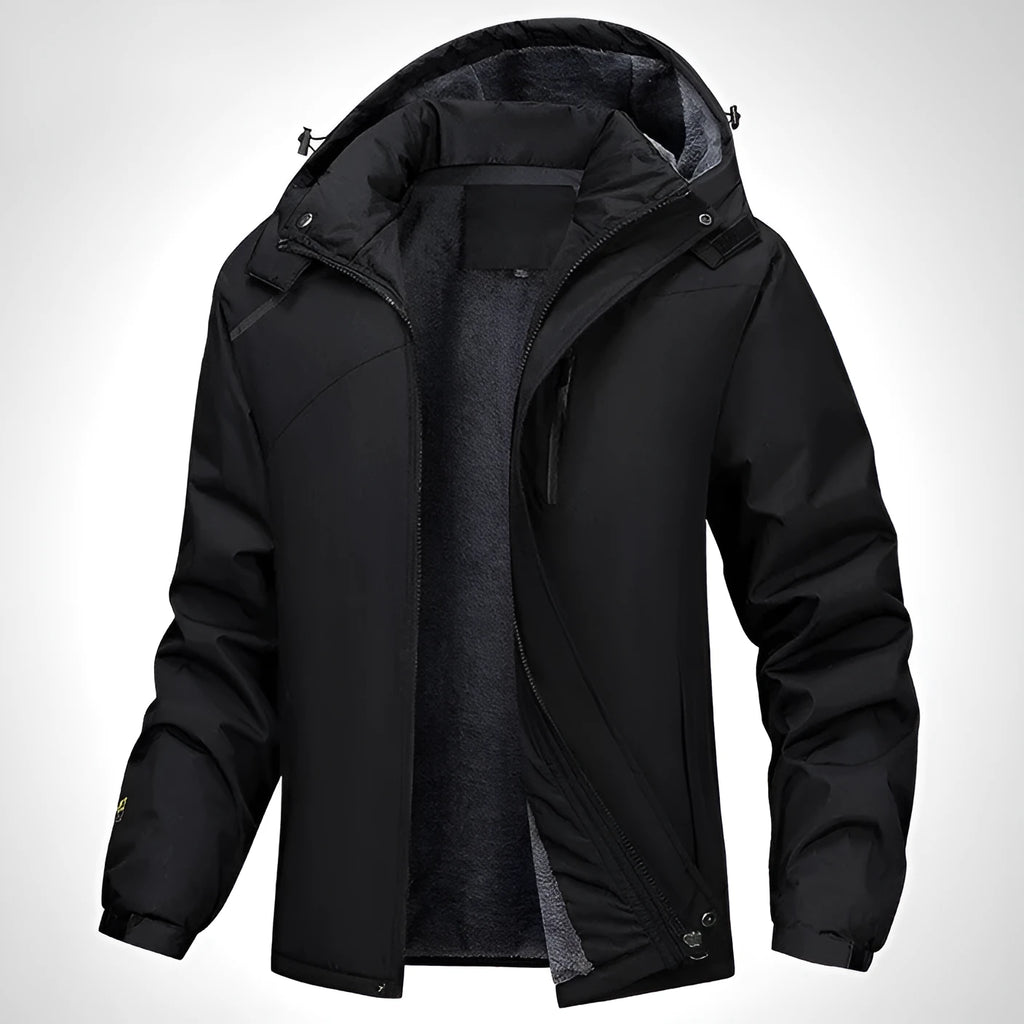 Man wearing a dark grey waterproof hooded plus-size coat outdoors.