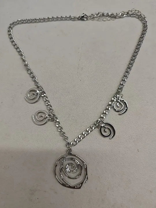 Women's spiral donut jewellery set showing matching gold necklace, bracelet, and earrings with geometric circle design