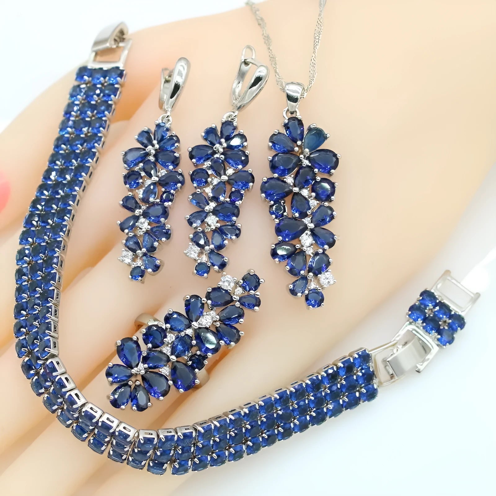 Dark blue copper inlaid zircon retro jewellery set including necklace, earrings, ring, and bracelet on display