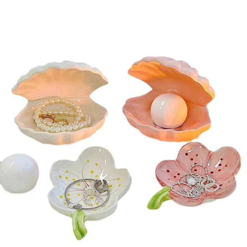 White porcelain girls ornament tray with small night light, shown in yellow and pink shell options.