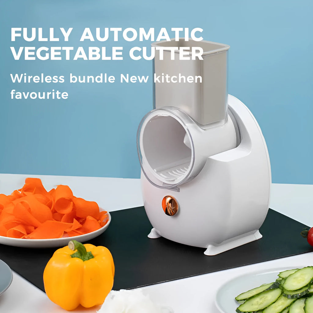 Electric vegetable slicer in white with feeding port, pressing rod, and blade barrel on a kitchen counter