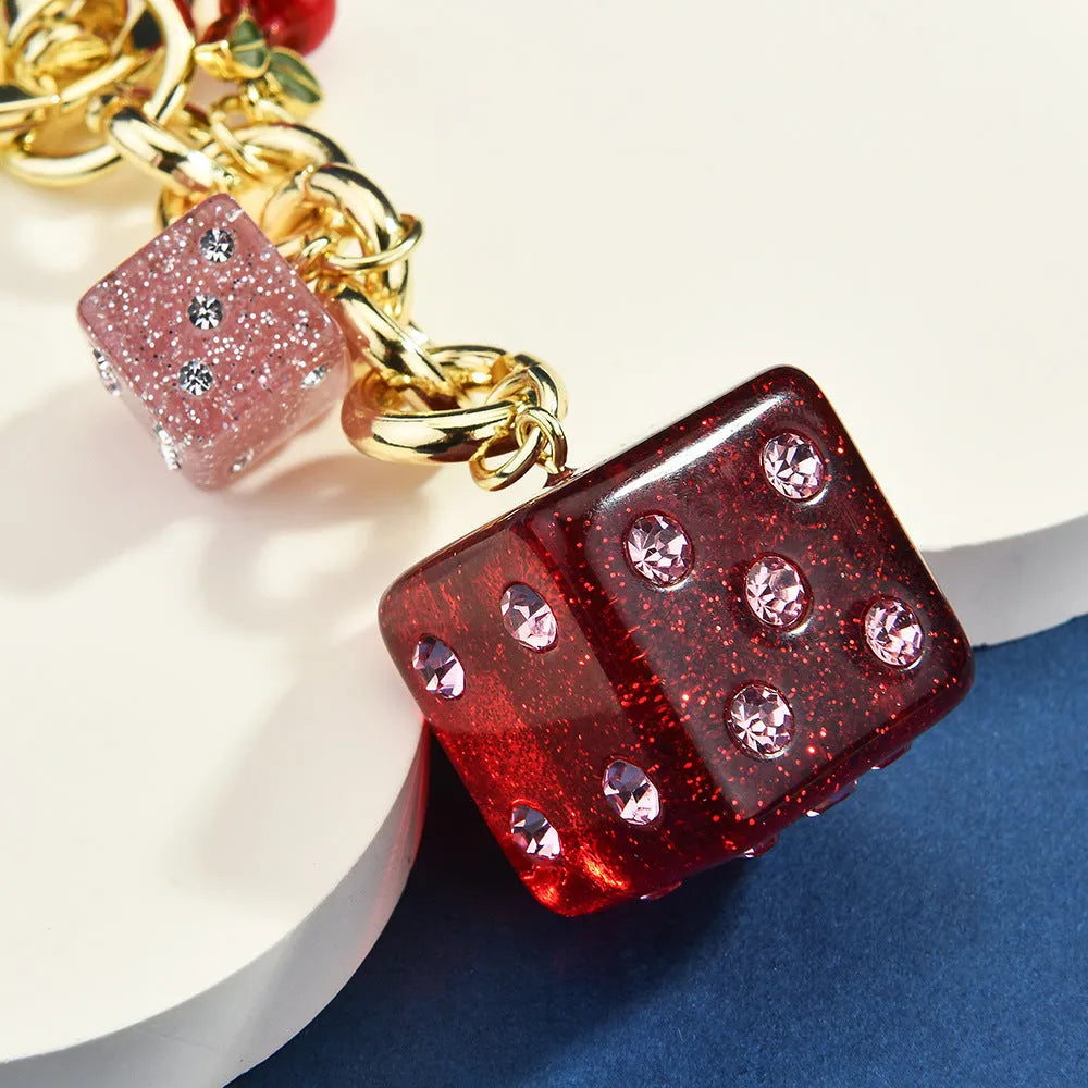 Square pattern metal keychain pendant with two-tone cherry dice design and electroplated finish