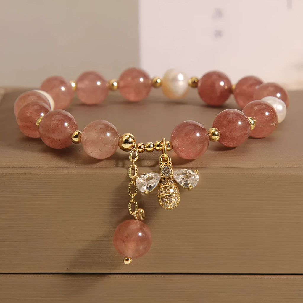 Women's beaded bracelet with strawberry quartz stones, freshwater pearls, and zircon accents on alloy.
