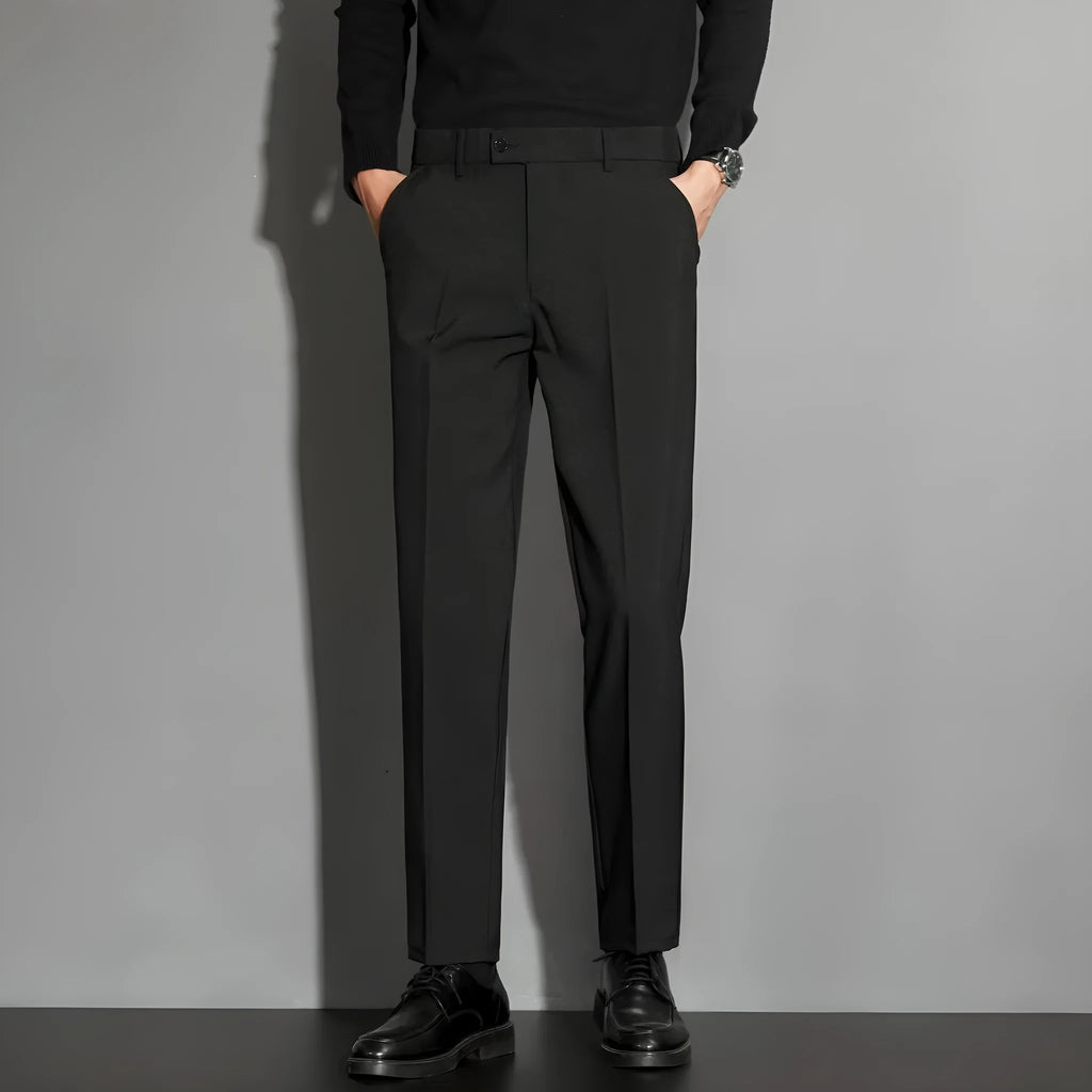 Men's straight-fit ankle-length suit trousers in a light gray colour, showing the draping effect.