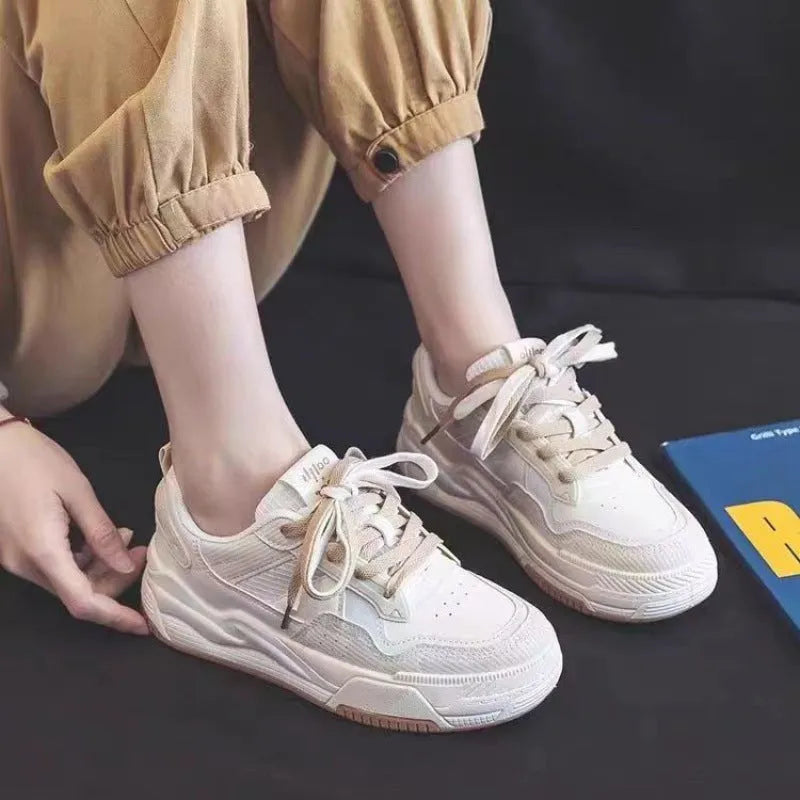Beige and pink low-top sneaker with a height-increasing rubber sole on a white background
