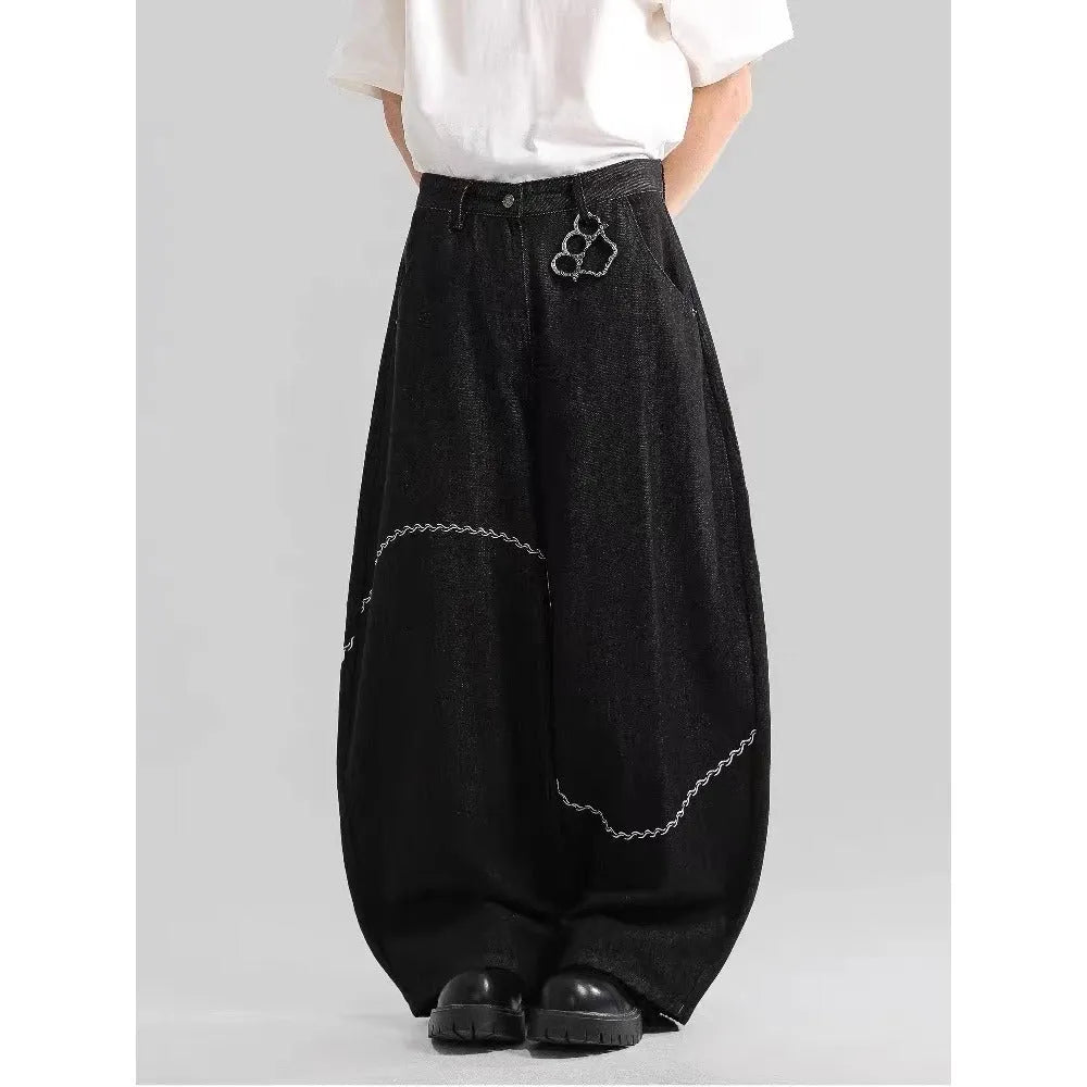 Black straight-leg denim trousers with mid waist and zip placket closure on hanger
