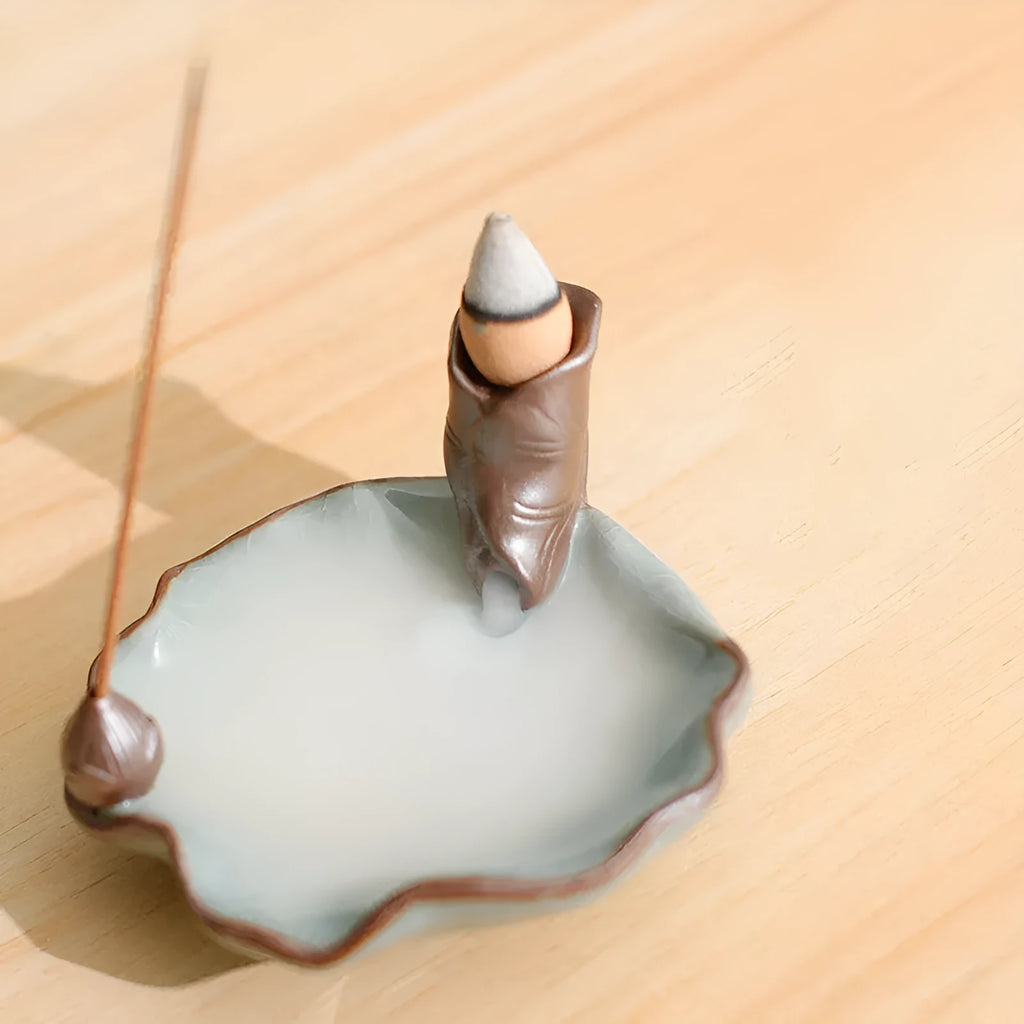 Square purple clay ceramic reverse flow incense burner with crystal glaze, featuring lotus and plum blossom designs.