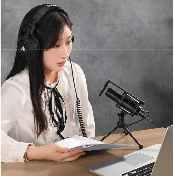 Black metal USB condenser recording microphone with 14mm diaphragm on desk with cable