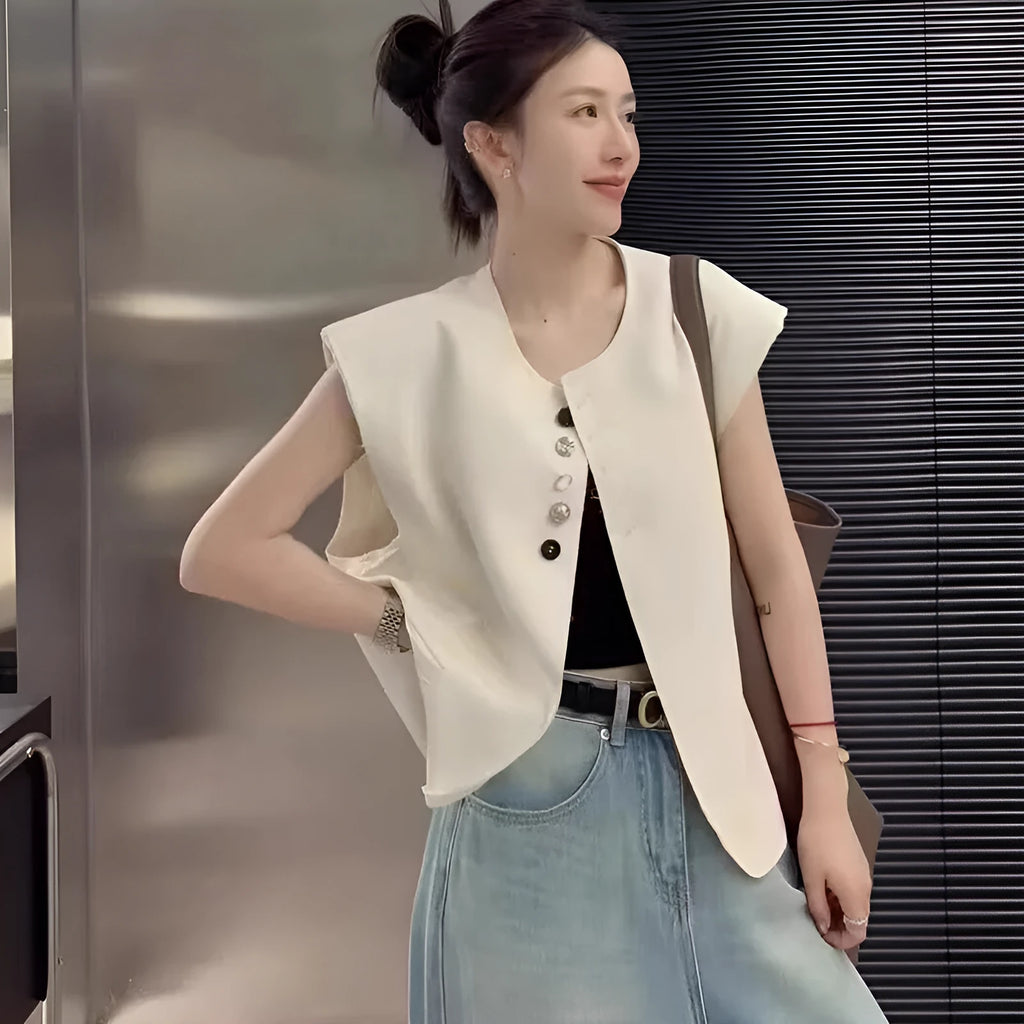 Women's loose-fit sleeveless polyester vest in black with visible pocket detail on the front.