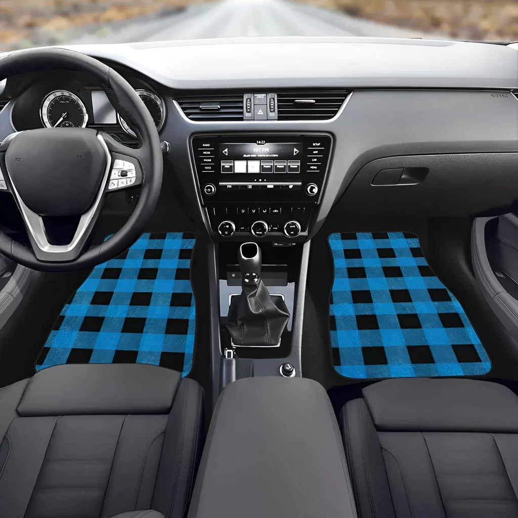 Black four-piece rubber car floor mat set with textured surface, shown fitted in a vehicle footwell.