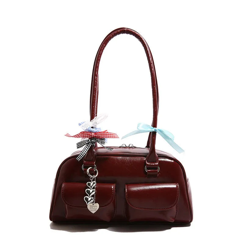 Brown PU leather women's retro pillow bag with double shoulder strap and flap closure.