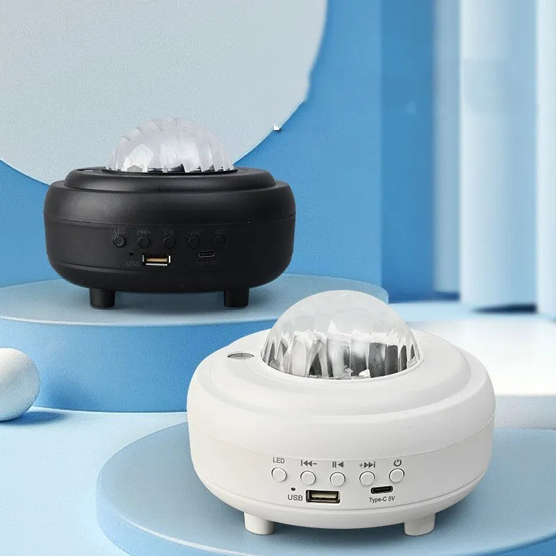 Galaxy star projector night light with 7 light effects and Bluetooth speaker in white rechargeable finish on a bedside table