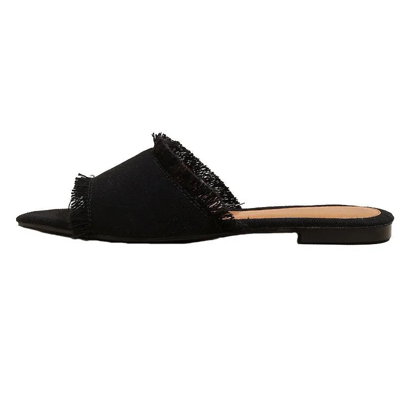 Women's denim slipper with tassel detail in apricot colour, showing flat profile and leather interior.