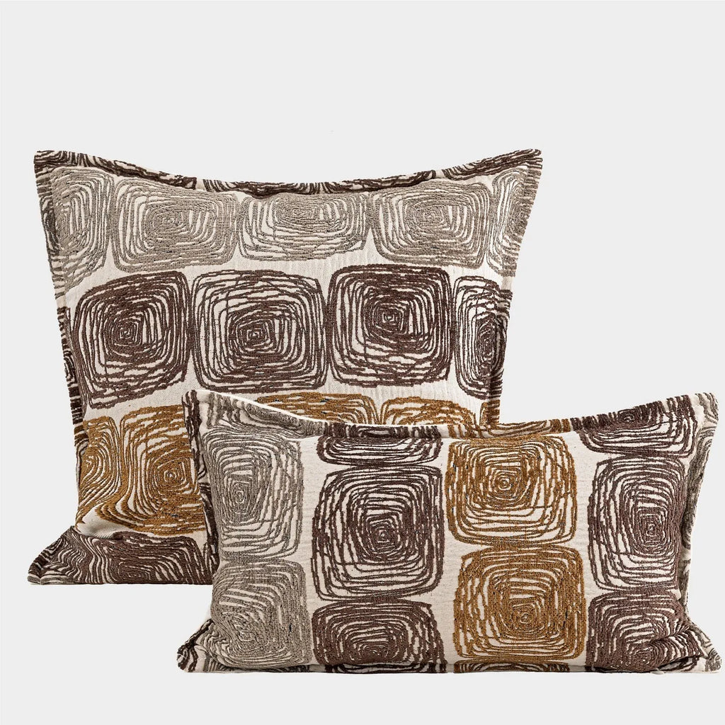 Abstract coil pattern pillow cover in cream and coffee colours with feather velvet texture