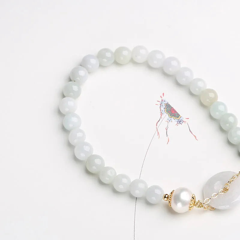 Traditional jade bracelet with peace buckle charm and pearl accents for women