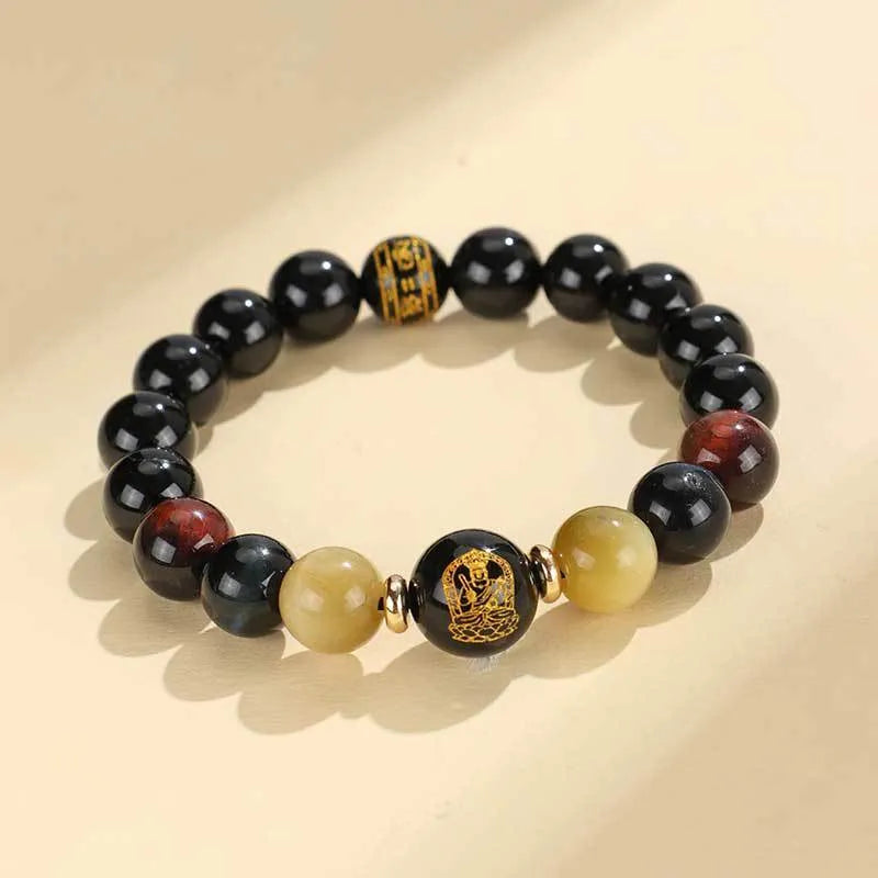 Black agate beaded bracelet with tiger eye stones in ethnic style on plain background