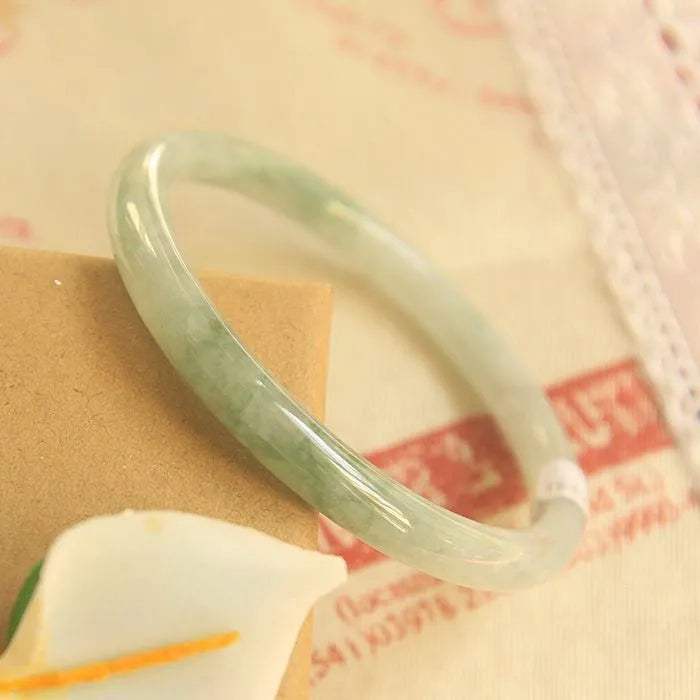 Green jade waxy bracelet with geometric beads and adjustable sizing from 53-64mm