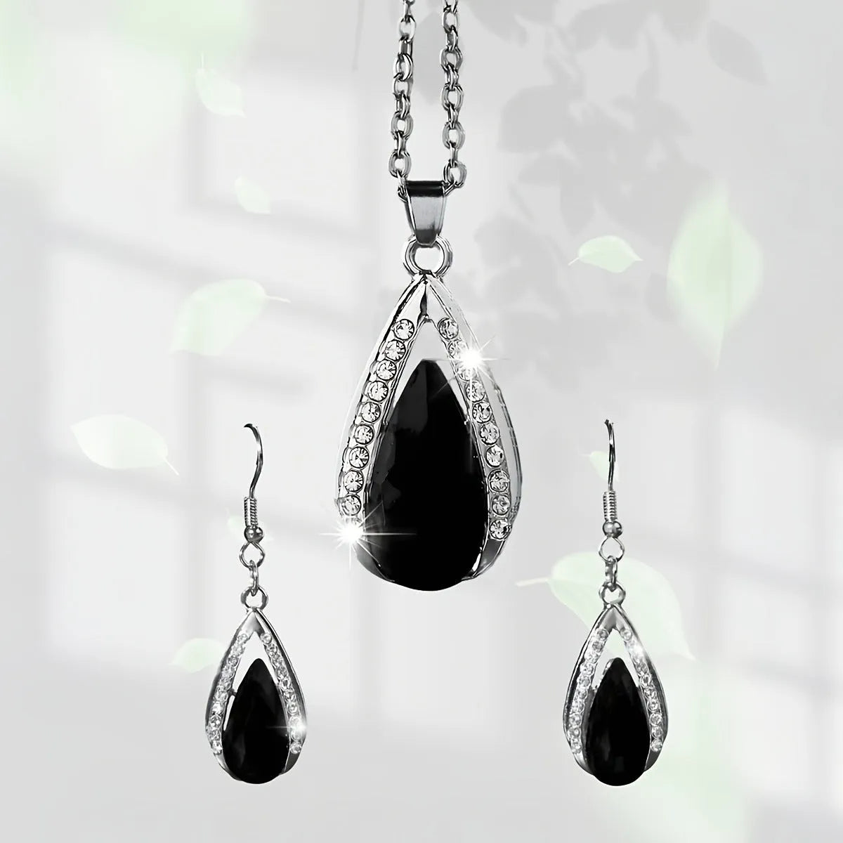 Teardrop pendant necklace and matching earrings set in black or red alloy with water droplet design elements