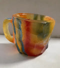 Purple resin coffee mug with 3D crystal texture and a handle on a wooden table.