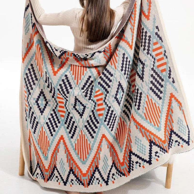 Bohemian style acrylic sofa throw blanket with tassel trim in a geometric pattern colour
