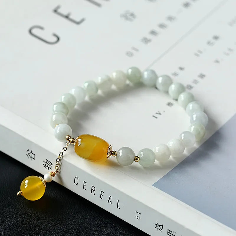 Women's bracelet with red agate round beads 7.5mm and hanging tassel in 14K gilded finish