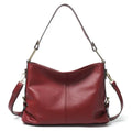 Genuine leather vertical crossbody bag in a square shape with an external sandwich pocket.