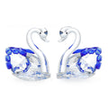 White crystal swan ornament in red, blue, pink, or purple on wooden desk