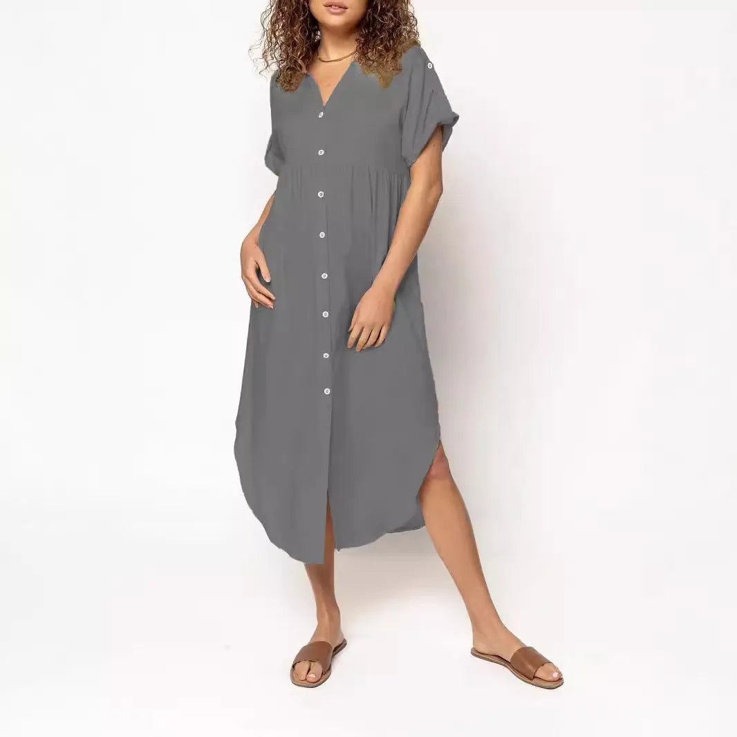 A loose-fitting, solid-colour button-down midi dress on a hanger, shown in apricot colour.