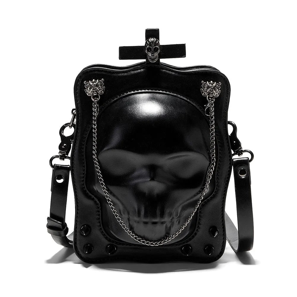 Black mini square crossbody bag with embossed skull design, chain accents, and zipper closure