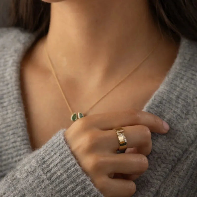 Gold electroplated women's ring with a shining zircon stone on a copper band.