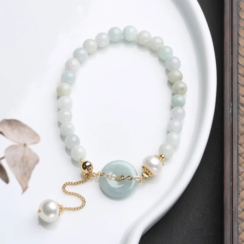 Traditional jade bracelet with peace buckle charm and pearl accents for women
