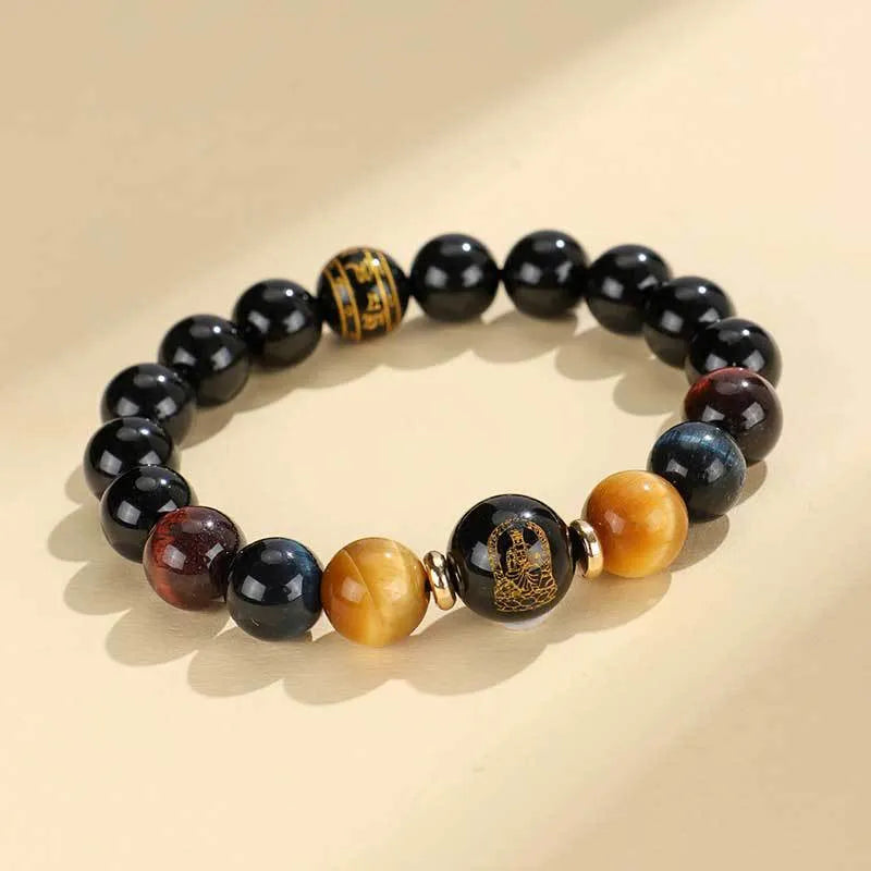 Black agate beaded bracelet with tiger eye stones in ethnic style on plain background