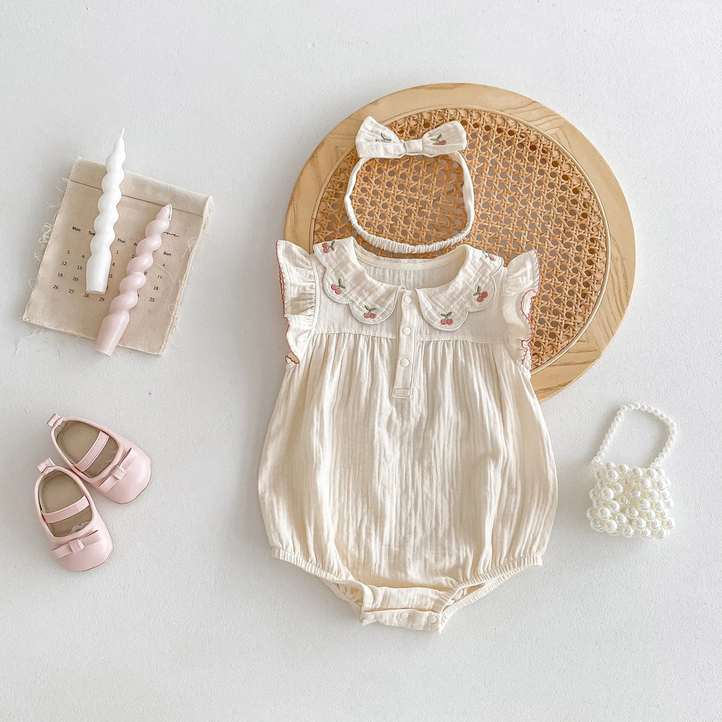 Summer cotton baby jumpsuit in apricot with double-breasted closure and matching hair band
