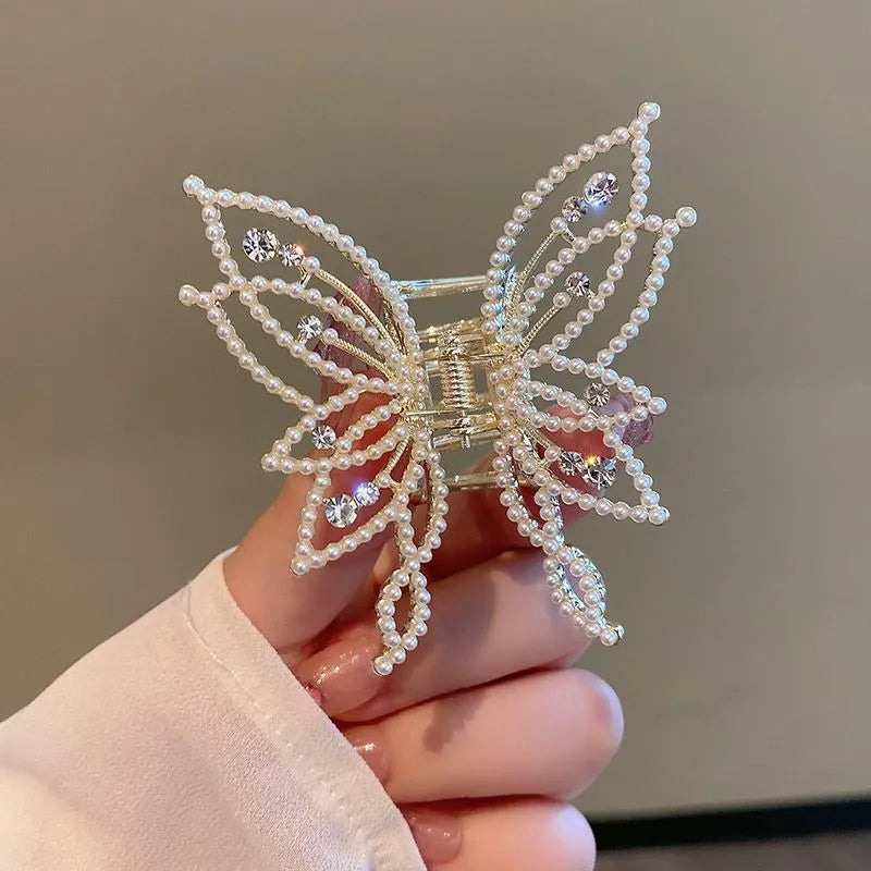 Butterfly-shaped alloy hair barrette for women with pearl or rhinestone decoration, shown from the front.