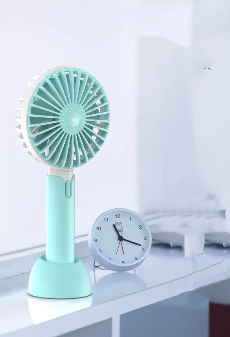 Blue handheld mini desktop USB fan with shaking head showing three-speed controls