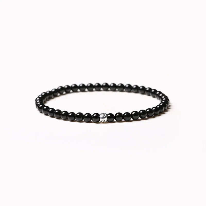Geometric bracelet with obsidian, blue san and black agate beads showing round and chamfered square designs