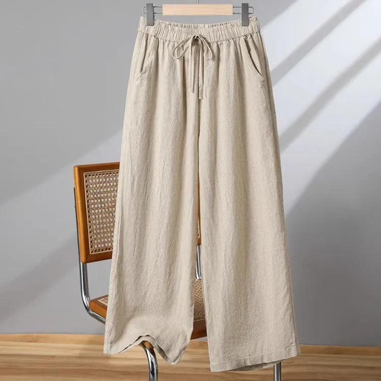 Women's apricot straight-leg casual trousers with a drawstring elastic waistband laid flat.